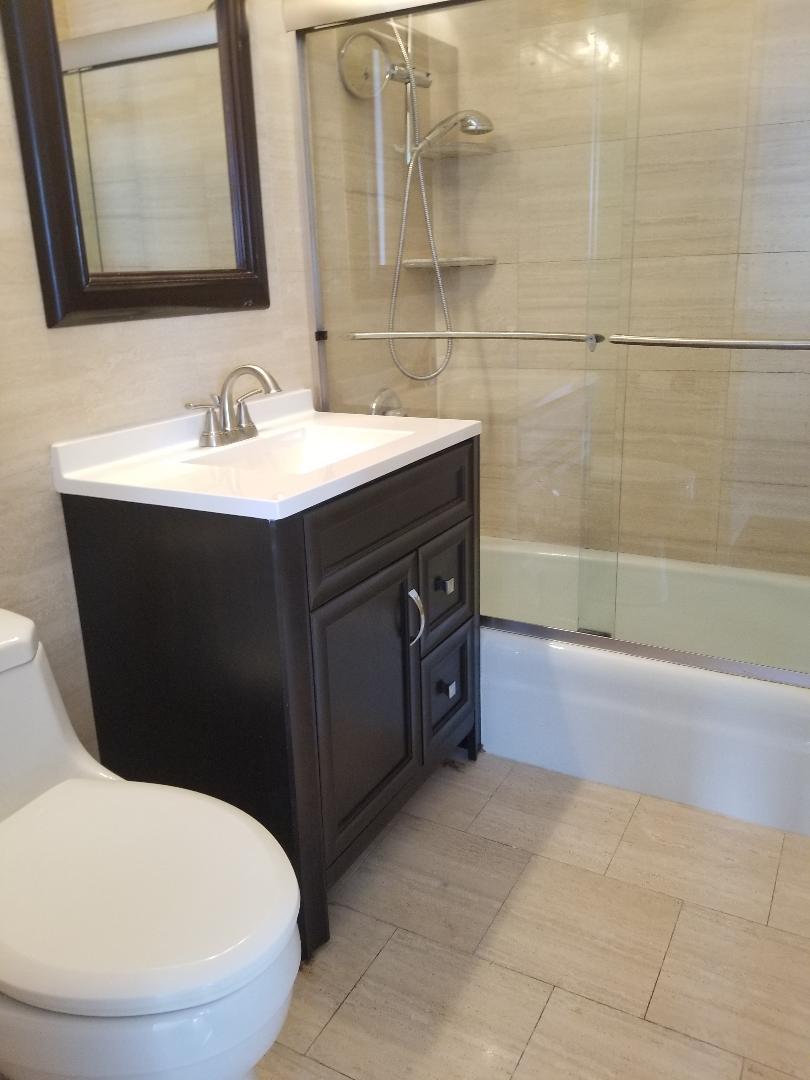 655 West Irving Park Road, Unit 5015 Chicago, IL 60613 - Photo 13 of 25 a bathroom with a sink and a mirror