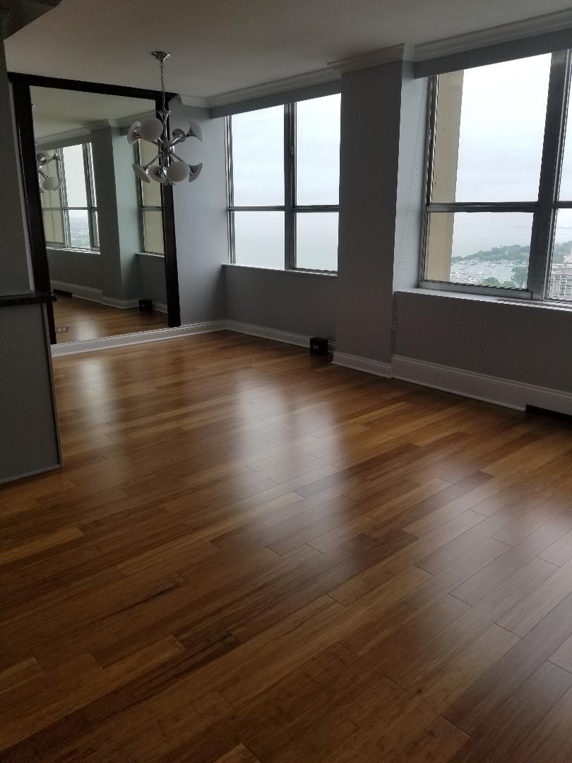 655 West Irving Park Road, Unit 5015 Chicago, IL 60613 - Photo 6 of 25 wooden floor in an empty room with a window