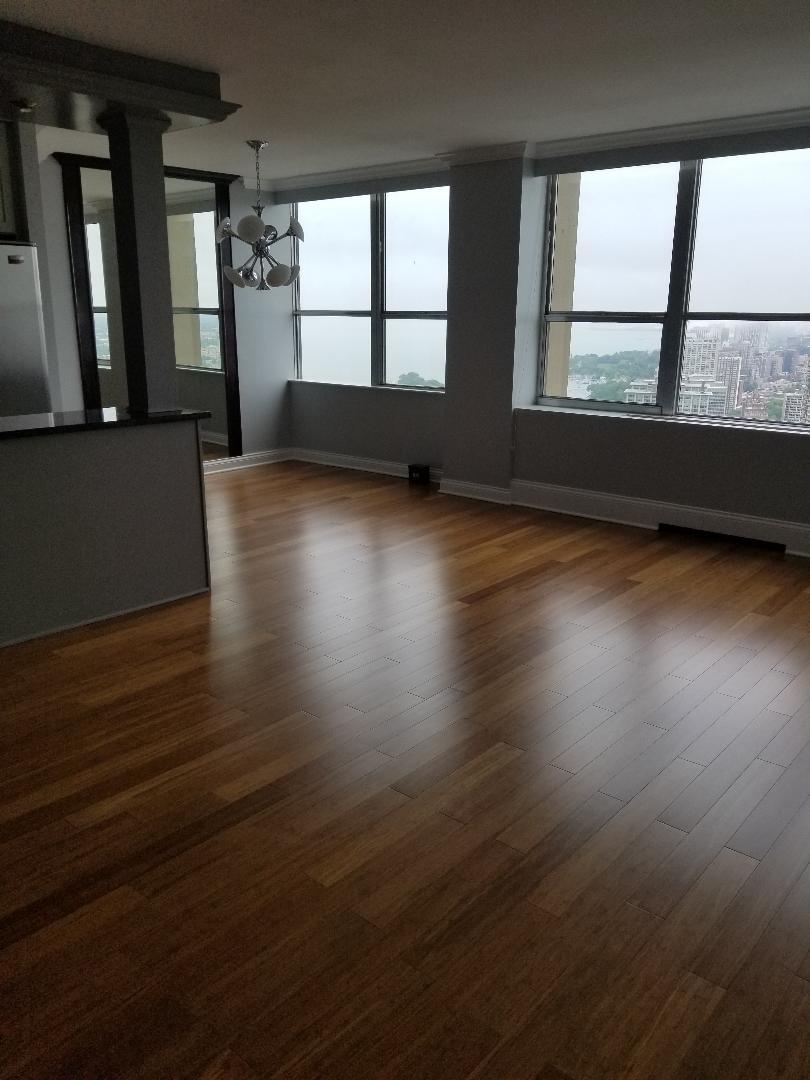 655 West Irving Park Road, Unit 5015 Chicago, IL 60613 - Photo 8 of 25 wooden floor in an empty room with a window