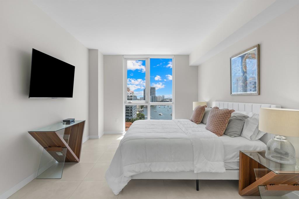 401 North Birch Road, Unit 1102 Fort Lauderdale, FL 33304 - Photo 18 of 31 a bedroom with a bed and a flat screen tv