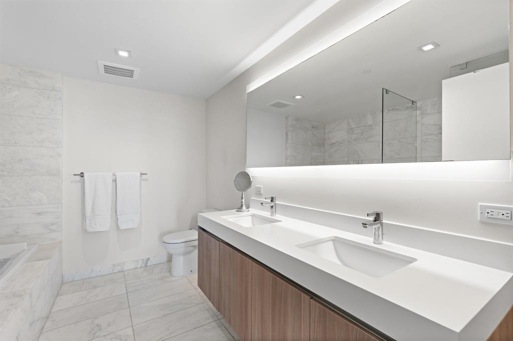 401 North Birch Road, Unit 1102 Fort Lauderdale, FL 33304 - Photo 20 of 31 a bathroom with a double vanity sink mirror and toilet