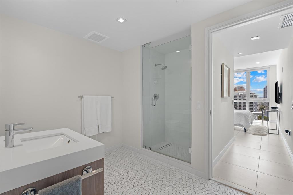 401 North Birch Road, Unit 1102 Fort Lauderdale, FL 33304 - Photo 9 of 31 a view of a bathroom with a sink and mirror