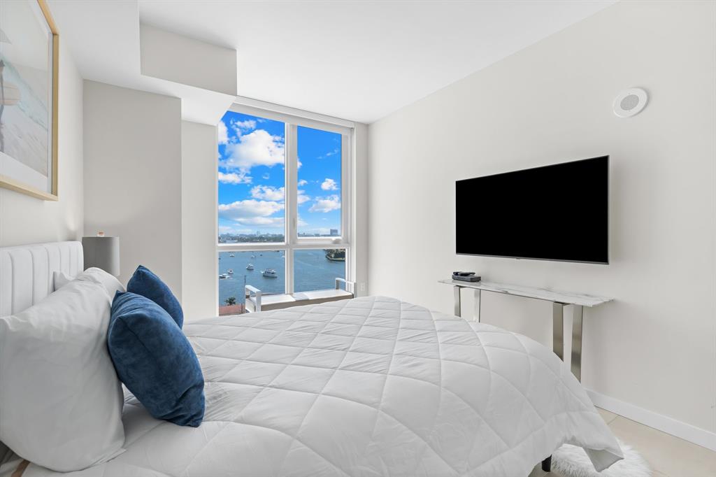 401 North Birch Road, Unit 1102 Fort Lauderdale, FL 33304 - Photo 10 of 31 a large bedroom with a bed and a flat screen tv