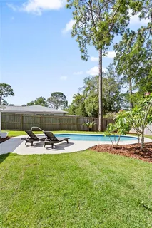 an aerial view of a house with a yard pool outdoor seating and yard