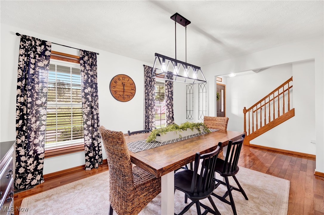 1247 Derbydale Road Akron, OH 44306 - Photo 11 of 45 Dining space open to stairs /inviting chandelier and hardwood floors