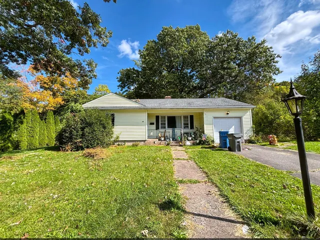 a front view of a house with swimming pool having outdoor seating