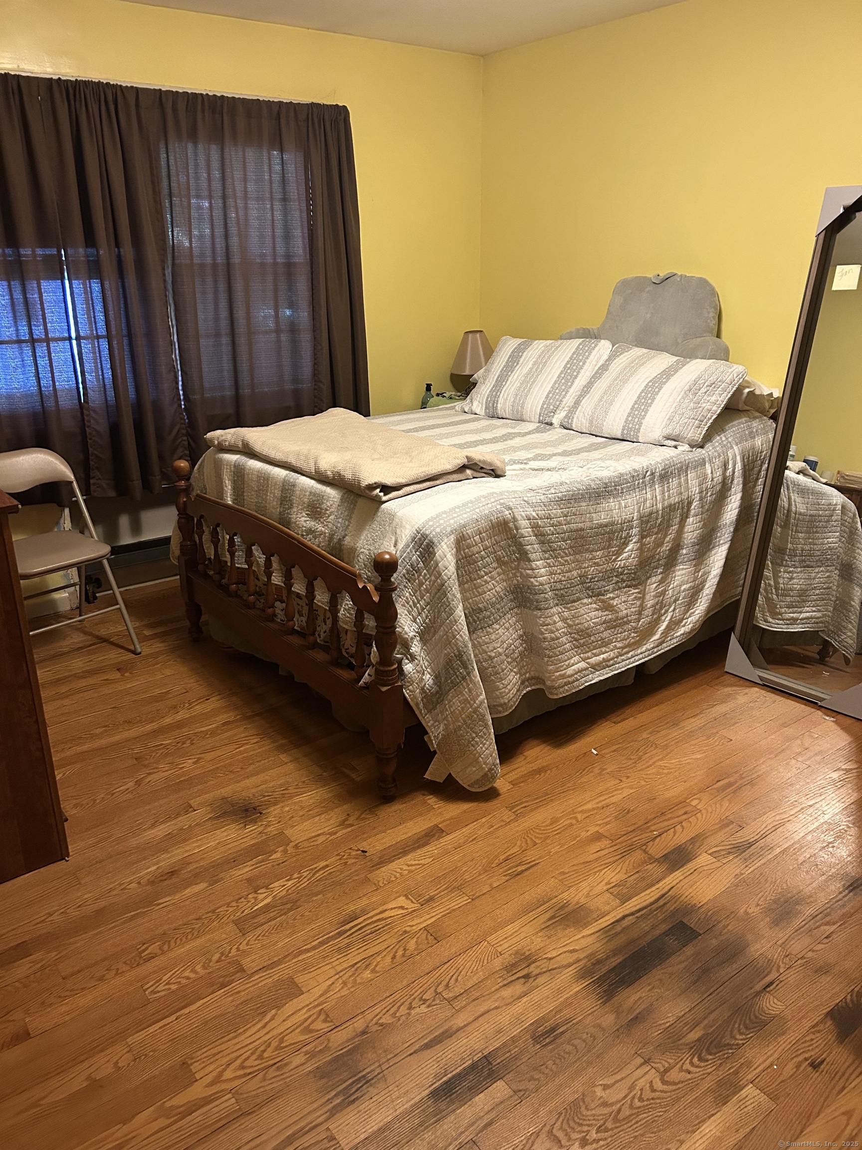 39 Alice Drive Manchester, CT 06042 - Photo 12 of 15 a bedroom with a bed and wooden floor