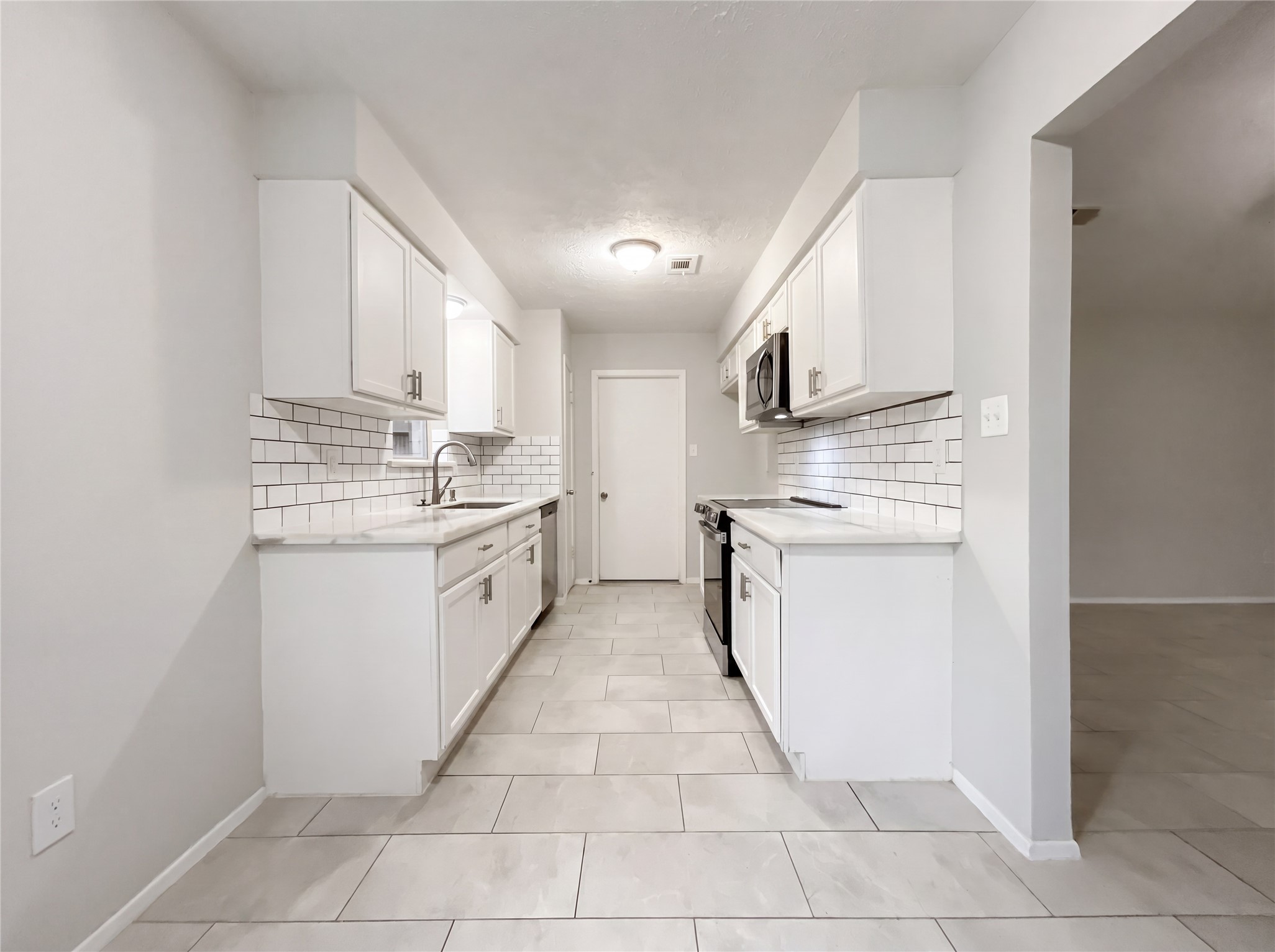 23110 Pennsgrove Road Spring, TX 77373 - Photo 6 of 16 a kitchen with a stove sink and a microwave