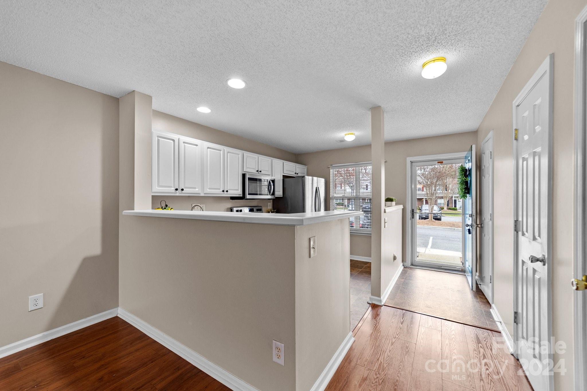 8368 Rudolph Road Charlotte, NC 28216 - Photo 11 of 43 a view of a kitchen with wooden floor