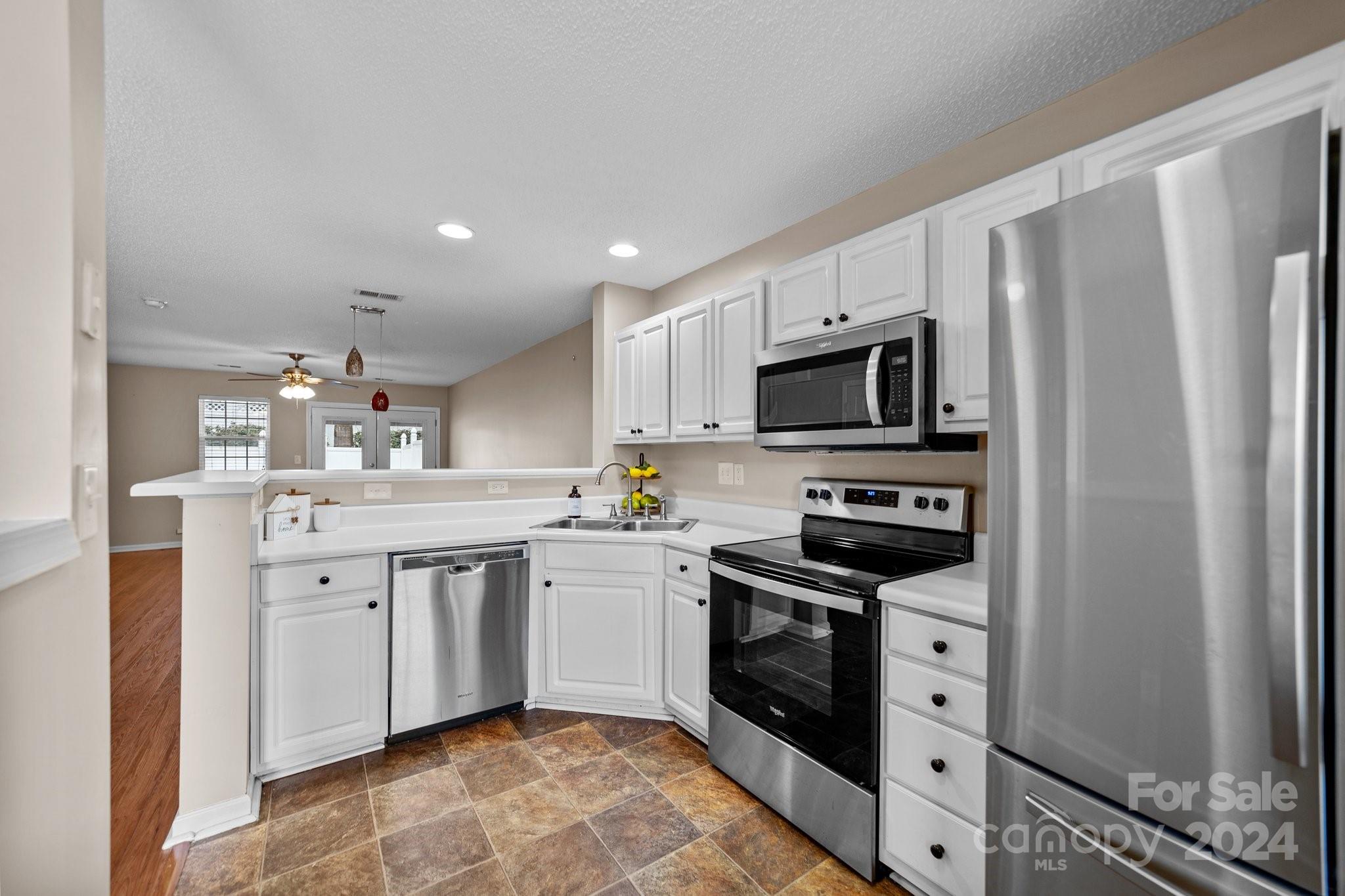 8368 Rudolph Road Charlotte, NC 28216 - Photo 13 of 43 a kitchen with granite countertop a sink stove and refrigerator