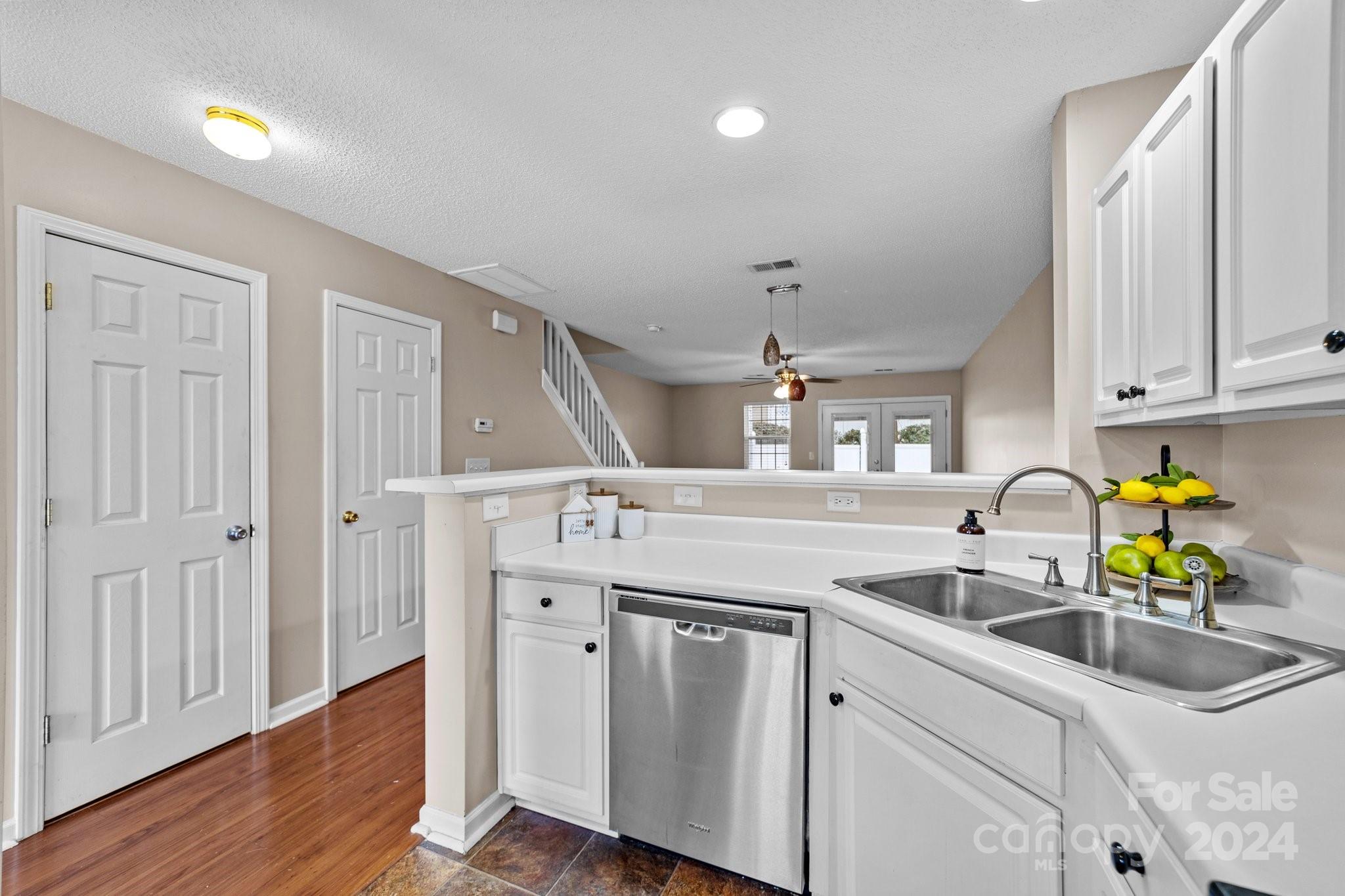 8368 Rudolph Road Charlotte, NC 28216 - Photo 14 of 43 a kitchen with a sink cabinets and wooden floors