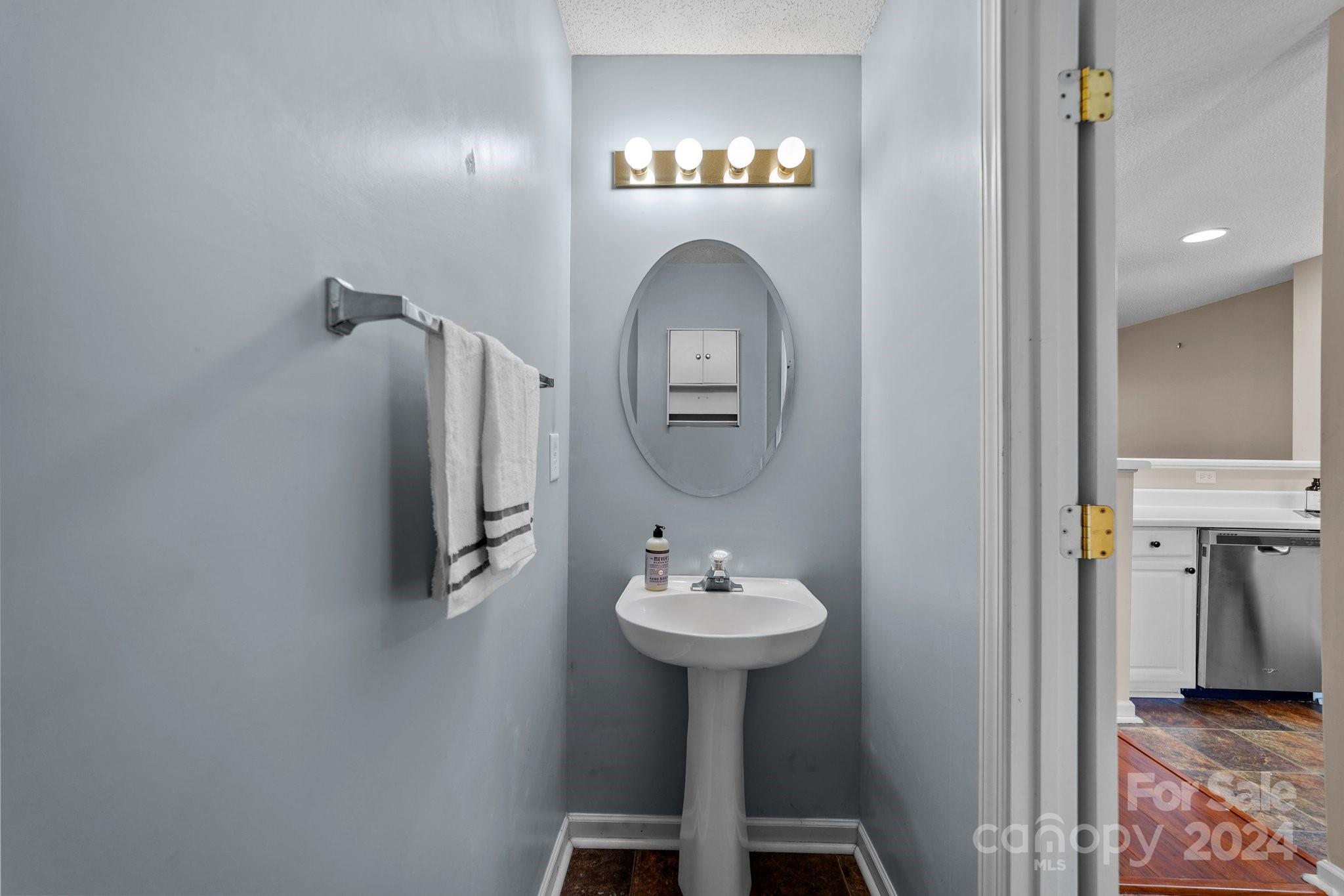 8368 Rudolph Road Charlotte, NC 28216 - Photo 17 of 43 a bathroom with a sink and a mirror