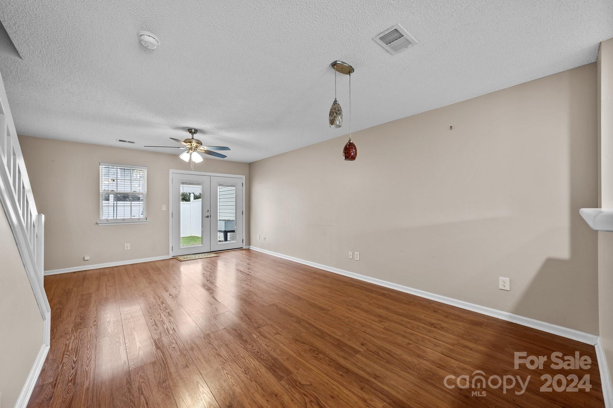 8368 Rudolph Road Charlotte, NC 28216 - Photo 18 of 43 an empty room with wooden floor and windows