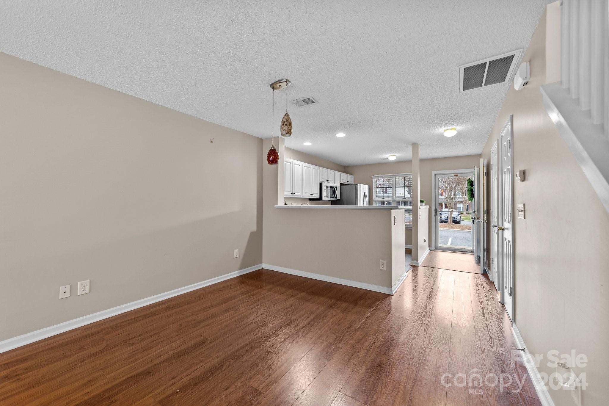 8368 Rudolph Road Charlotte, NC 28216 - Photo 19 of 43 a view of wooden floor and windows in an empty room