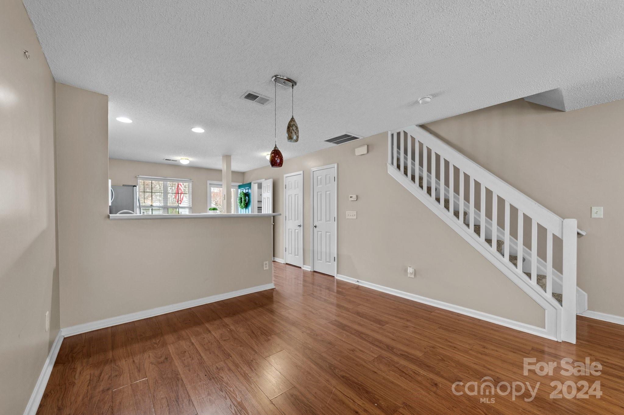 8368 Rudolph Road Charlotte, NC 28216 - Photo 20 of 43 a view of a hallway with wooden floor and entryway