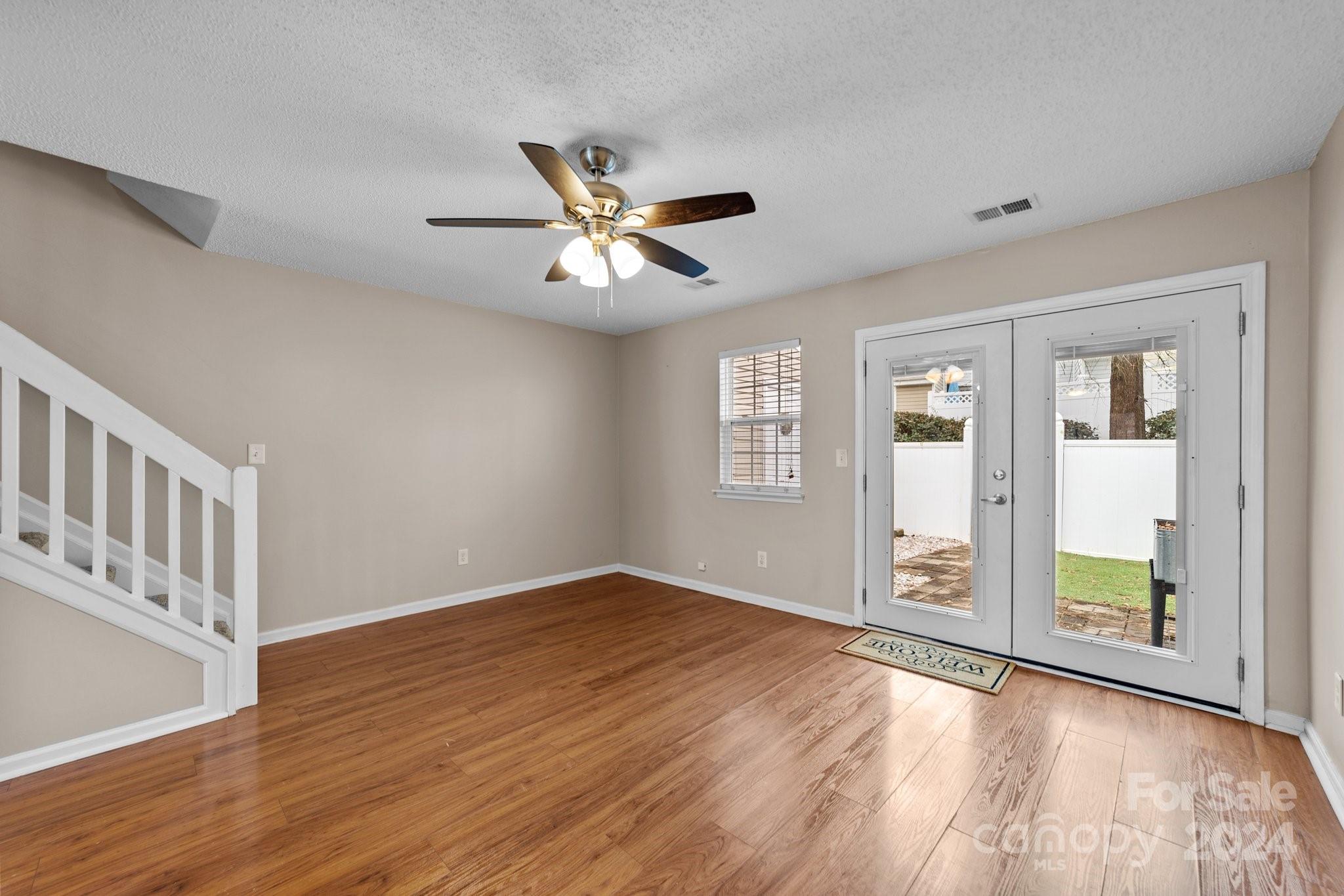 8368 Rudolph Road Charlotte, NC 28216 - Photo 21 of 43 wooden floor in an empty room with a window