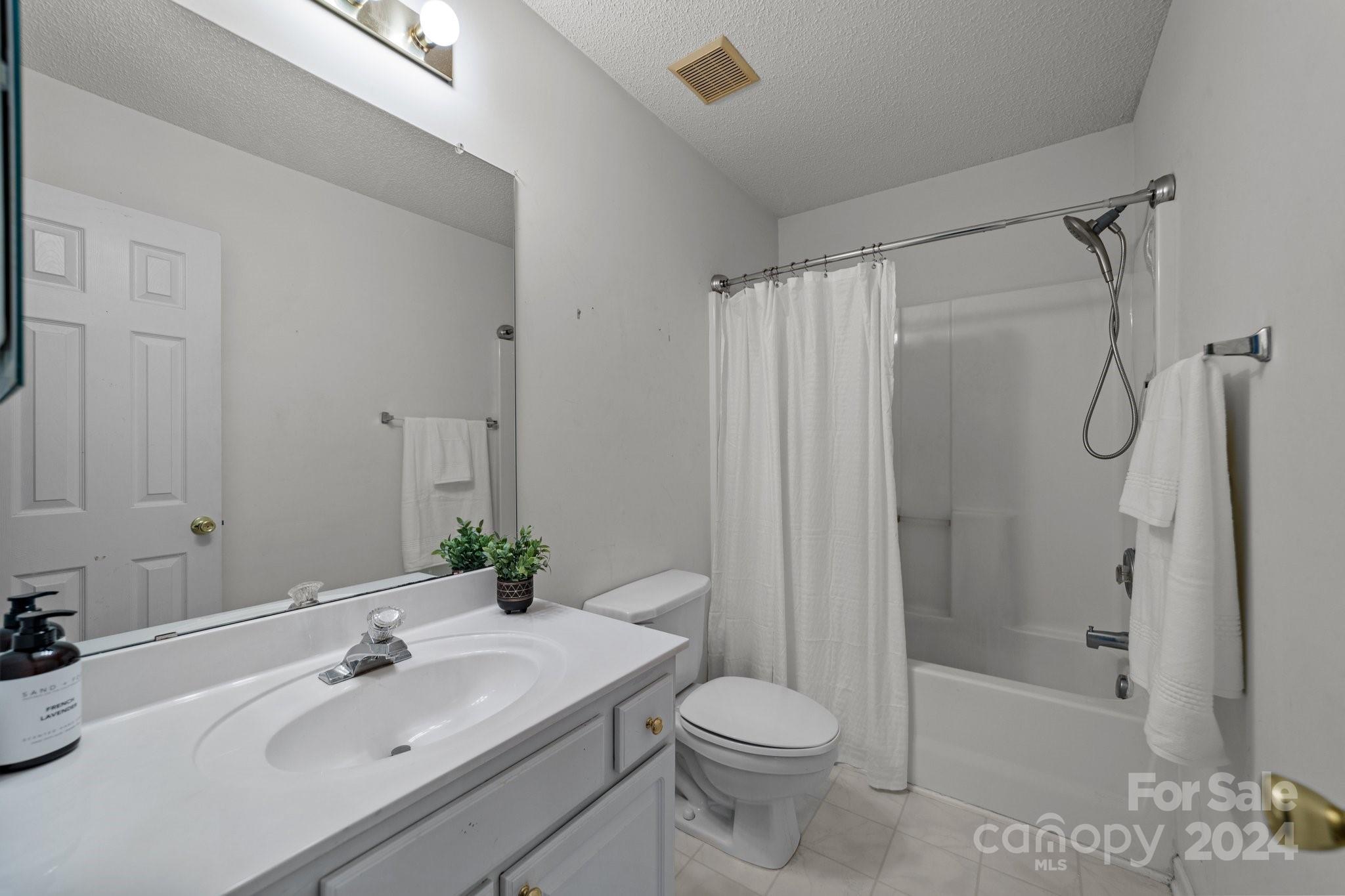 8368 Rudolph Road Charlotte, NC 28216 - Photo 30 of 43 a bathroom with a sink toilet and shower