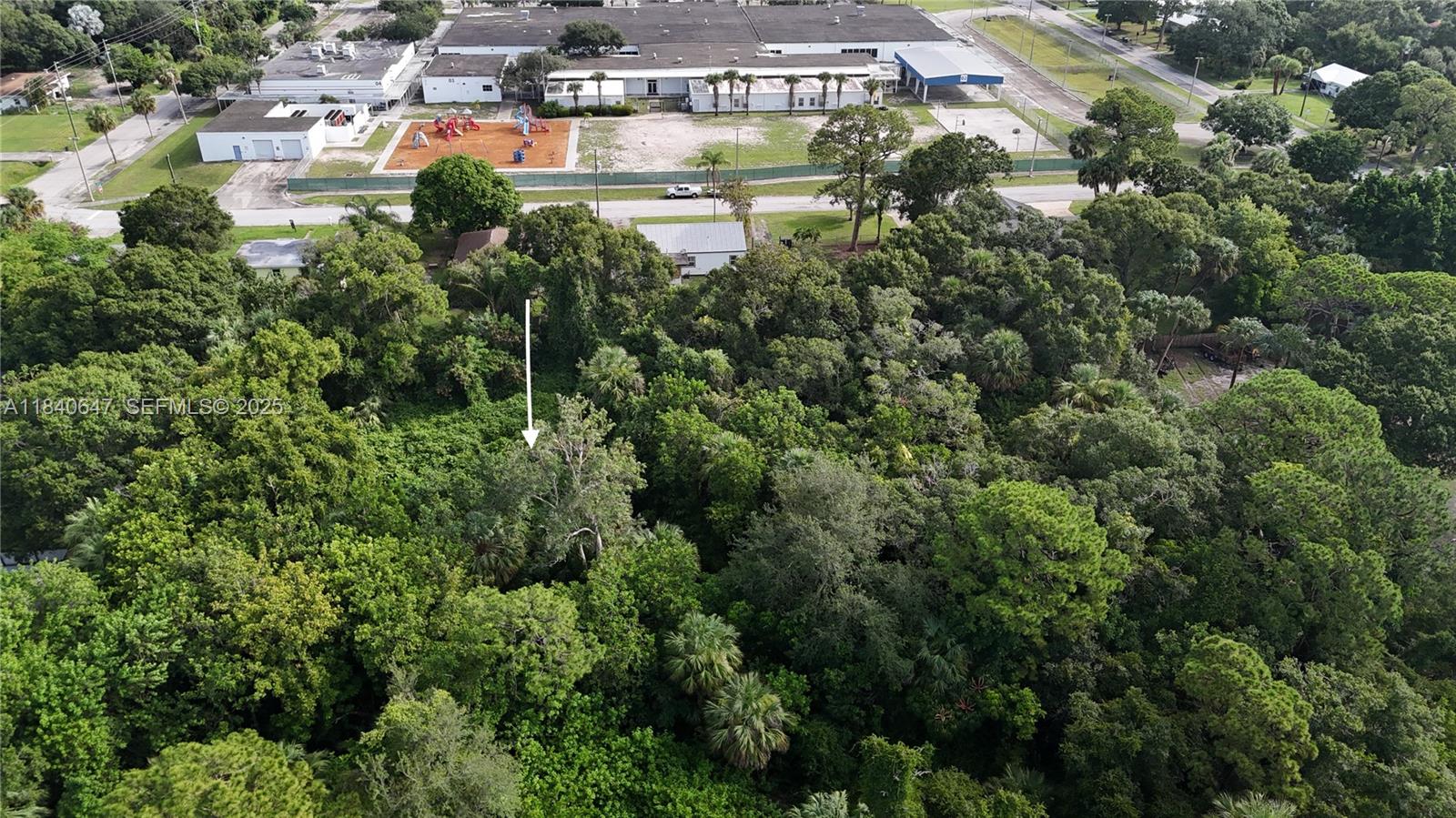 1 Tennessee Avenue Fort Pierce, FL 34947 - Photo 12 of 17 an aerial view of a house with a yard and lake view