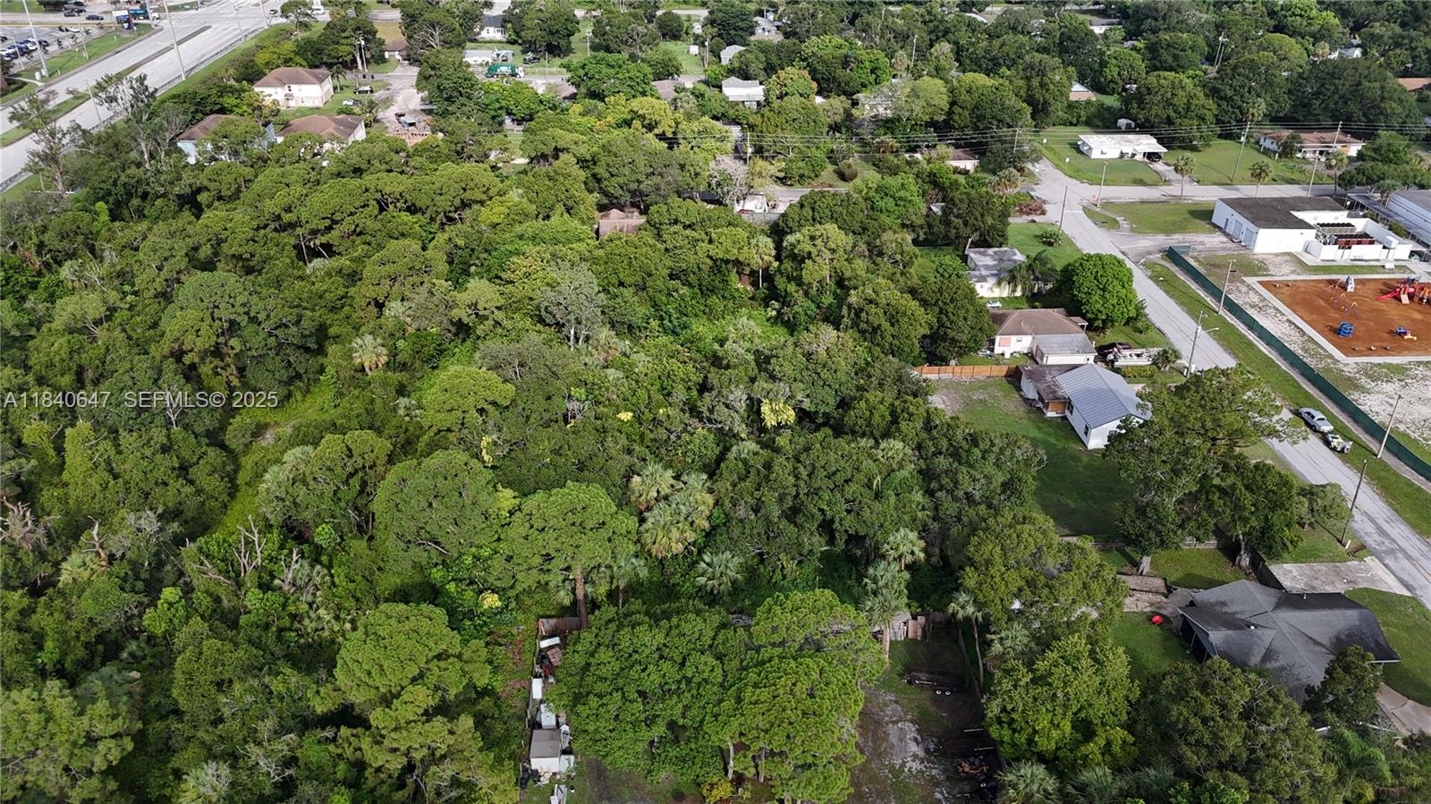 1 Tennessee Avenue Fort Pierce, FL 34947 - Photo 16 of 17 an aerial view of residential houses with outdoor space and trees