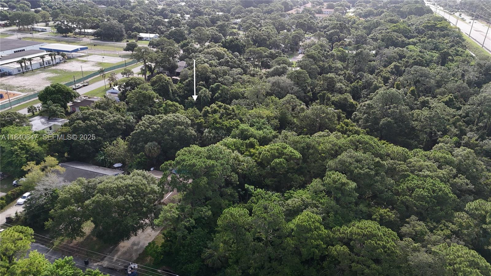 1 Tennessee Avenue Fort Pierce, FL 34947 - Photo 9 of 17 an aerial view of residential houses with outdoor space and trees