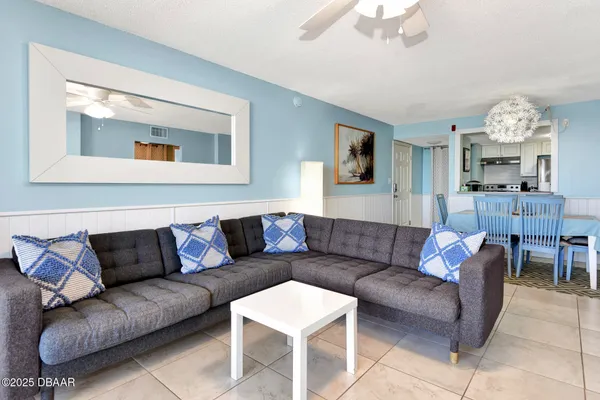 a living room with furniture and a large mirror