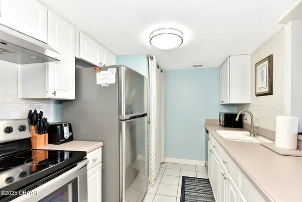 a kitchen with a sink appliances and cabinets