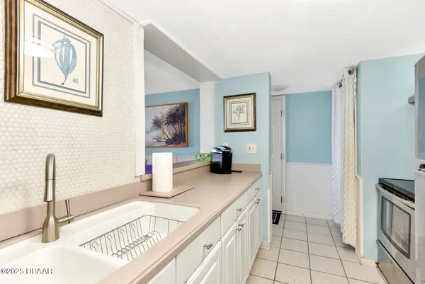 a kitchen with stainless steel appliances granite countertop a sink and a refrigerator