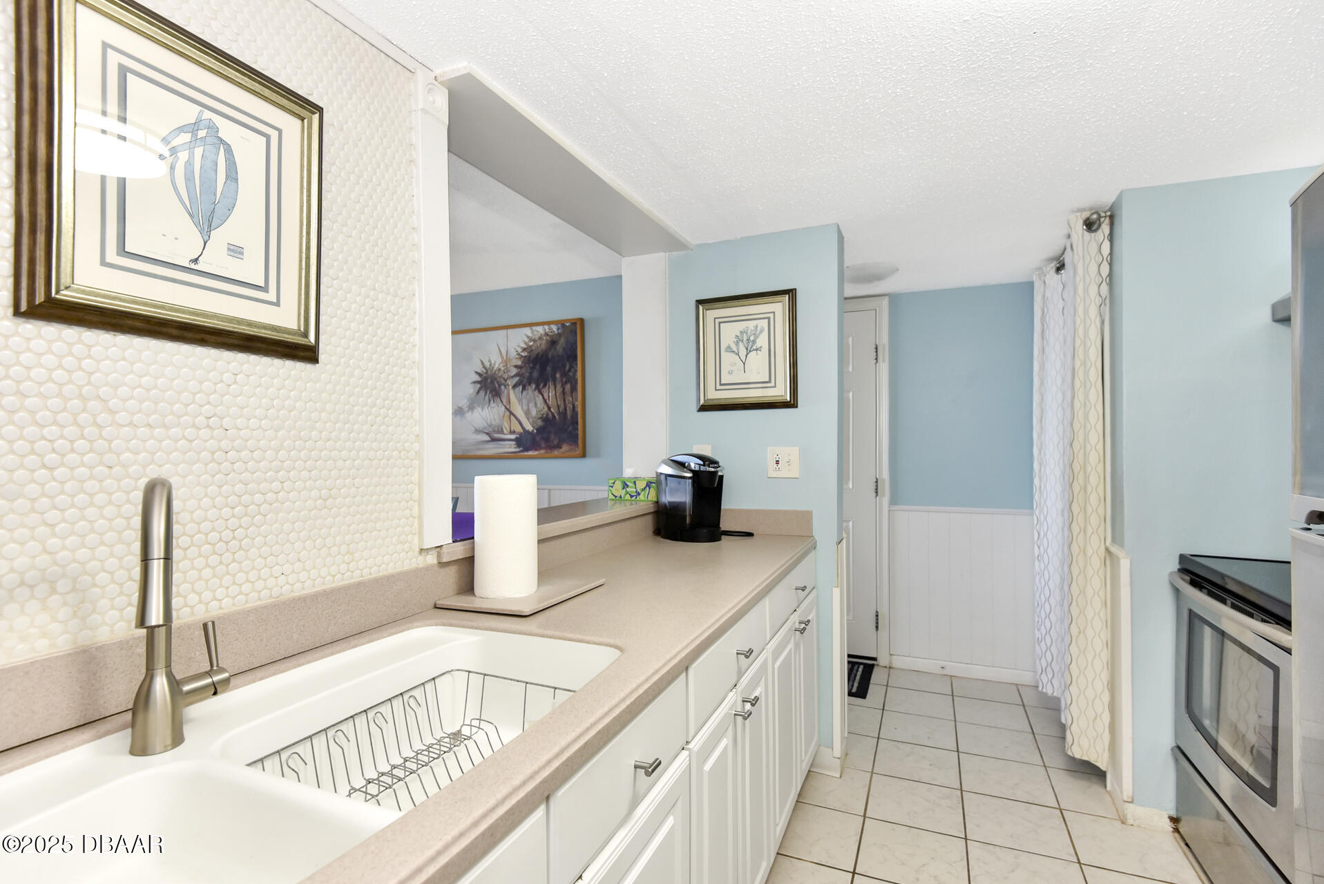 4495 South Atlantic Avenue, Unit 4040 Ponce Inlet, FL 32127 - Photo 14 of 45 a kitchen with stainless steel appliances granite countertop a sink and a refrigerator