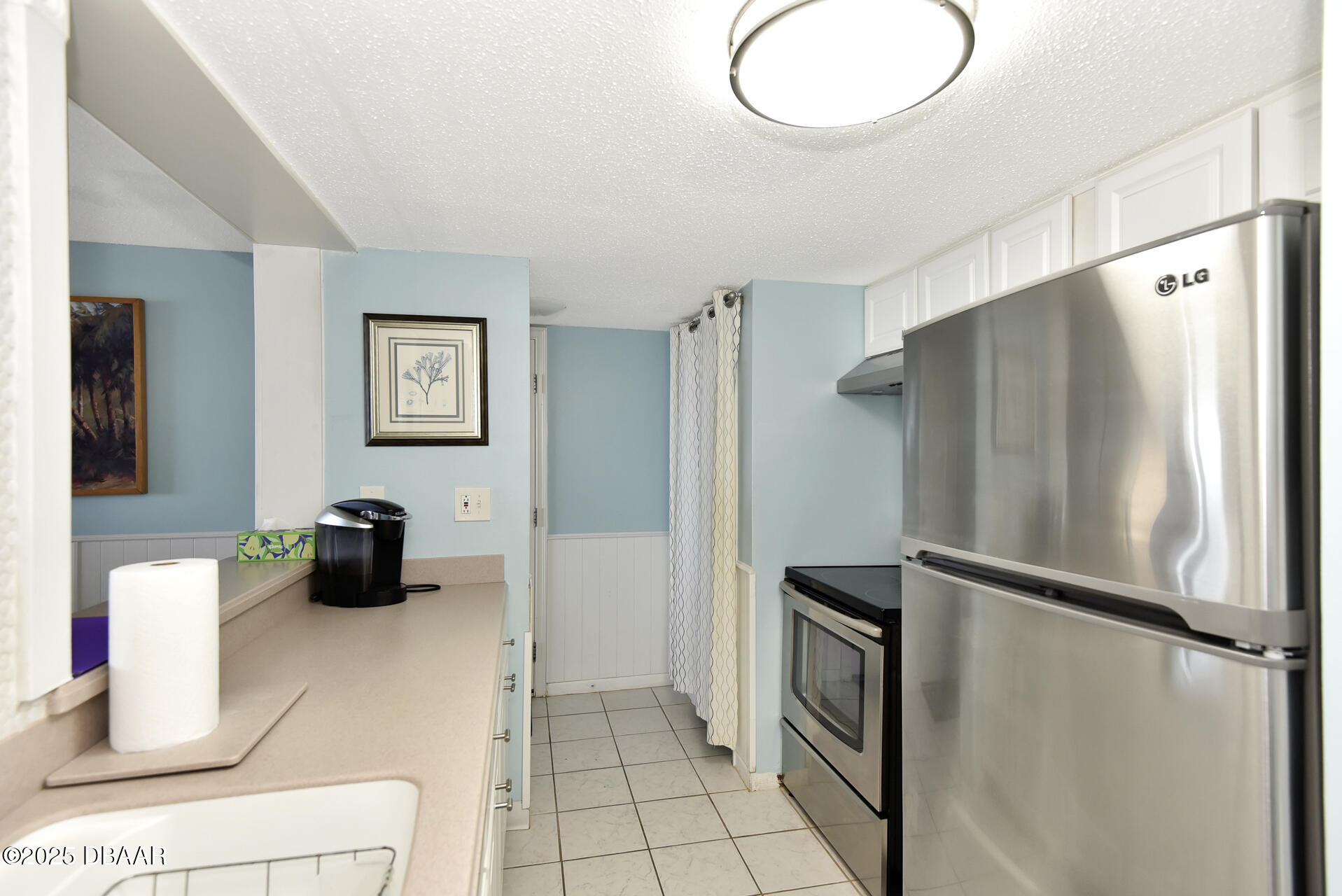 4495 South Atlantic Avenue, Unit 4040 Ponce Inlet, FL 32127 - Photo 16 of 45 a kitchen with a refrigerator and a sink