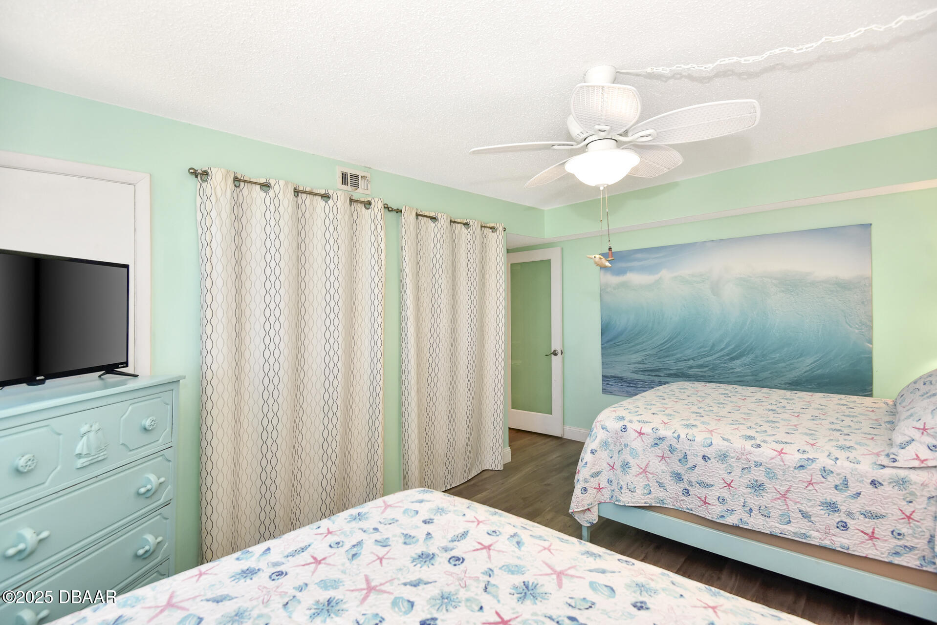 4495 South Atlantic Avenue, Unit 4040 Ponce Inlet, FL 32127 - Photo 22 of 45 a bedroom with a bed and a flat screen tv