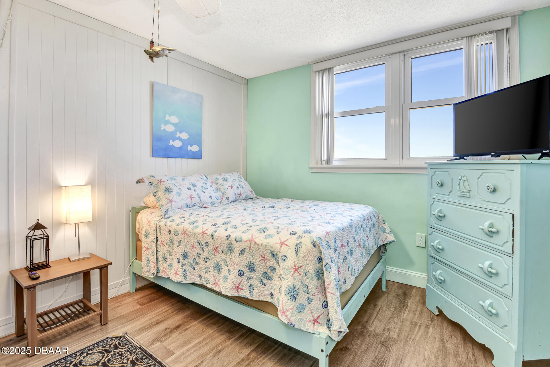 4495 South Atlantic Avenue, Unit 4040 Ponce Inlet, FL 32127 - Photo 24 of 45 a bedroom with a bed and a flat tv screen on dresser