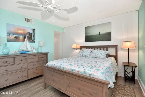 a bedroom with a bed and a mirror on dresser