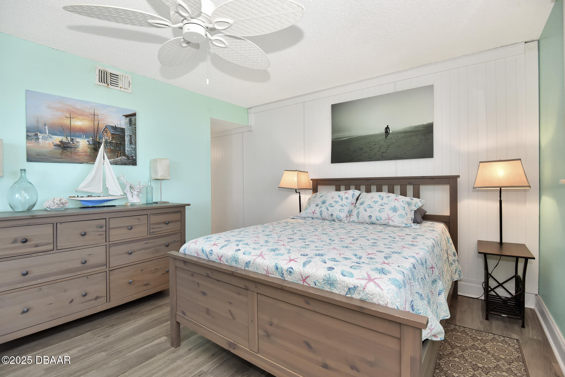 4495 South Atlantic Avenue, Unit 4040 Ponce Inlet, FL 32127 - Photo 27 of 45 a bedroom with a bed and a mirror on dresser