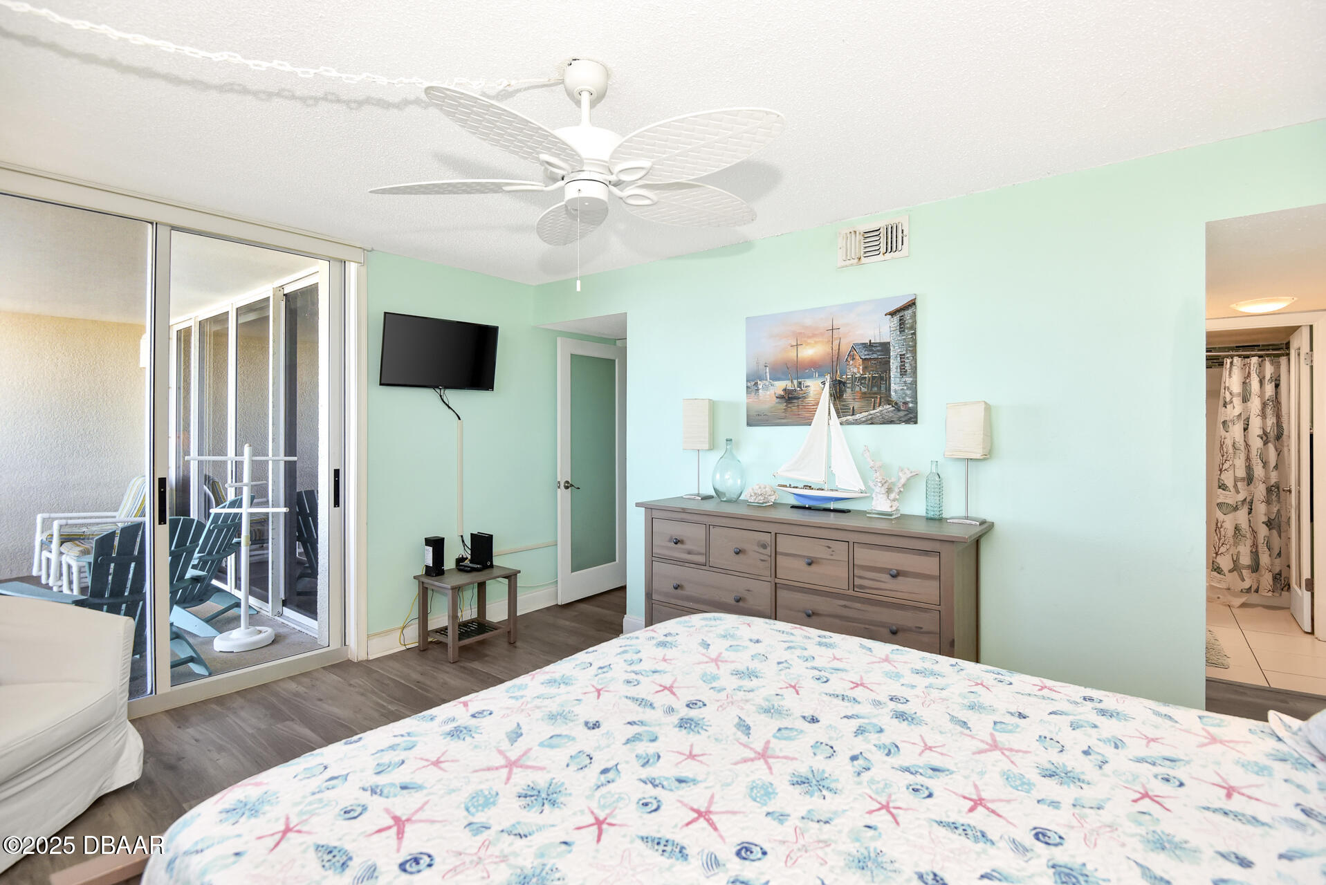 4495 South Atlantic Avenue, Unit 4040 Ponce Inlet, FL 32127 - Photo 28 of 45 a bedroom with a bed and a dresser