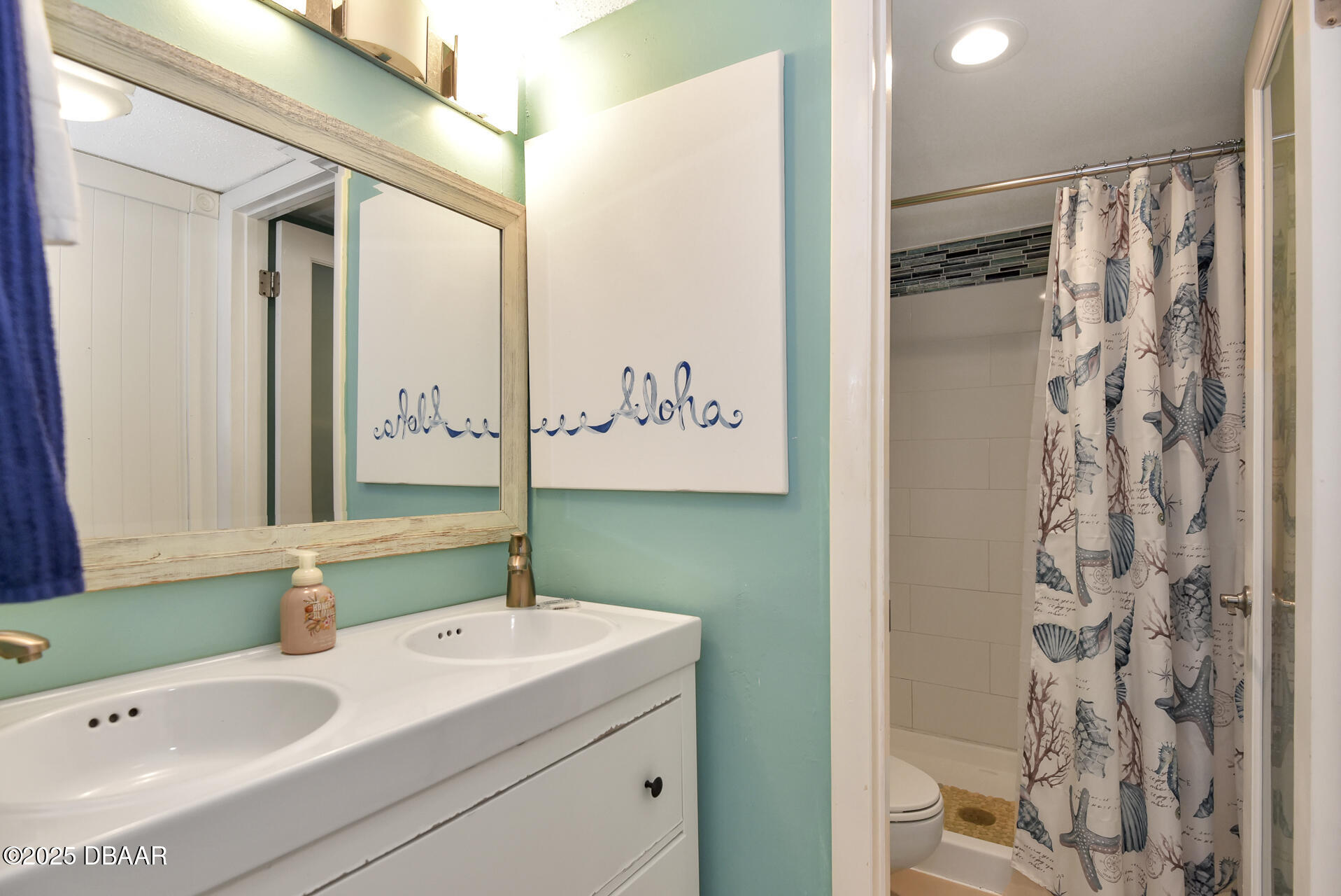 4495 South Atlantic Avenue, Unit 4040 Ponce Inlet, FL 32127 - Photo 29 of 45 a bathroom with a sink and a mirror
