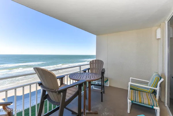 a view of a room with furniture and a table