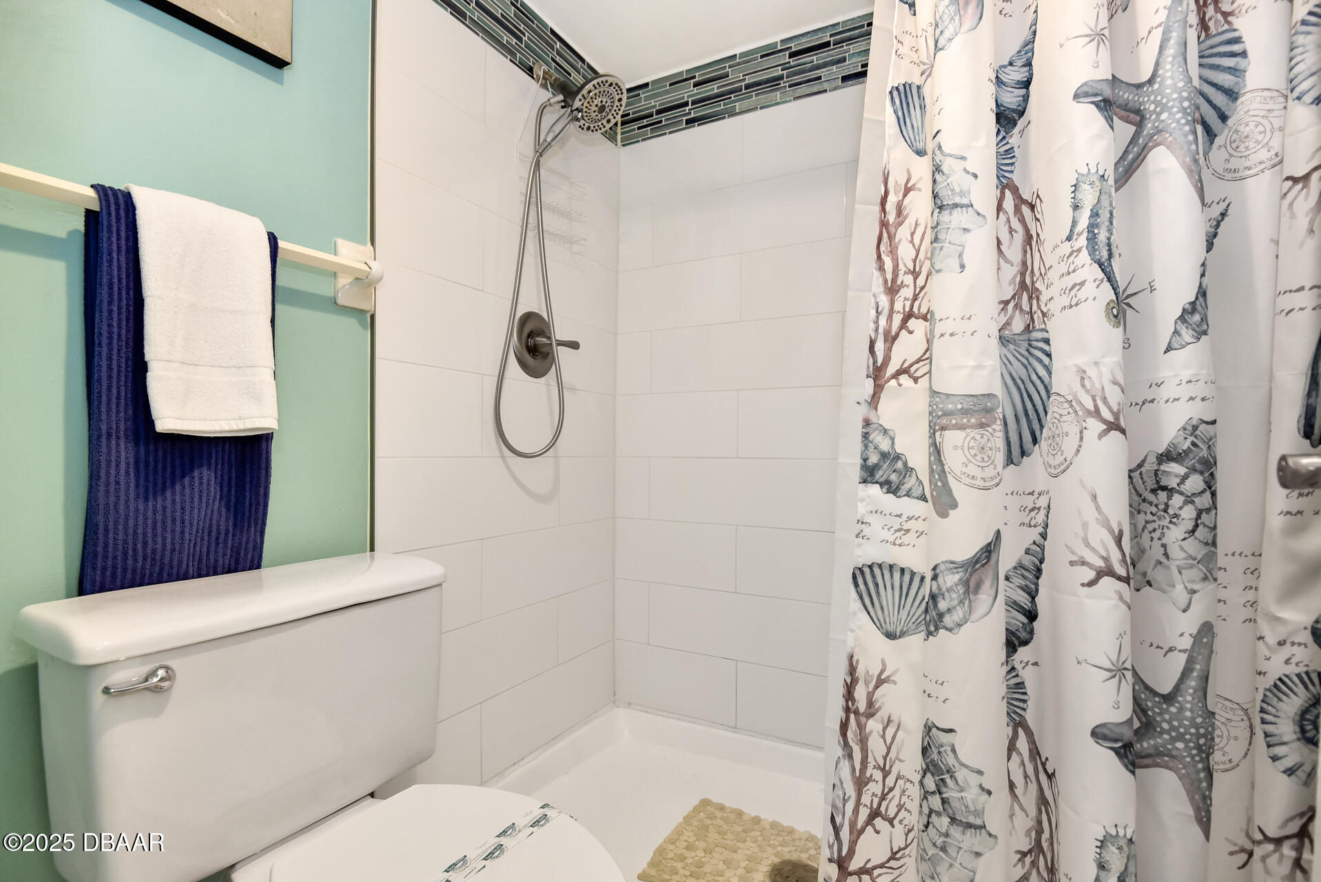 4495 South Atlantic Avenue, Unit 4040 Ponce Inlet, FL 32127 - Photo 31 of 45 a bathroom with a shower curtain and a toilet