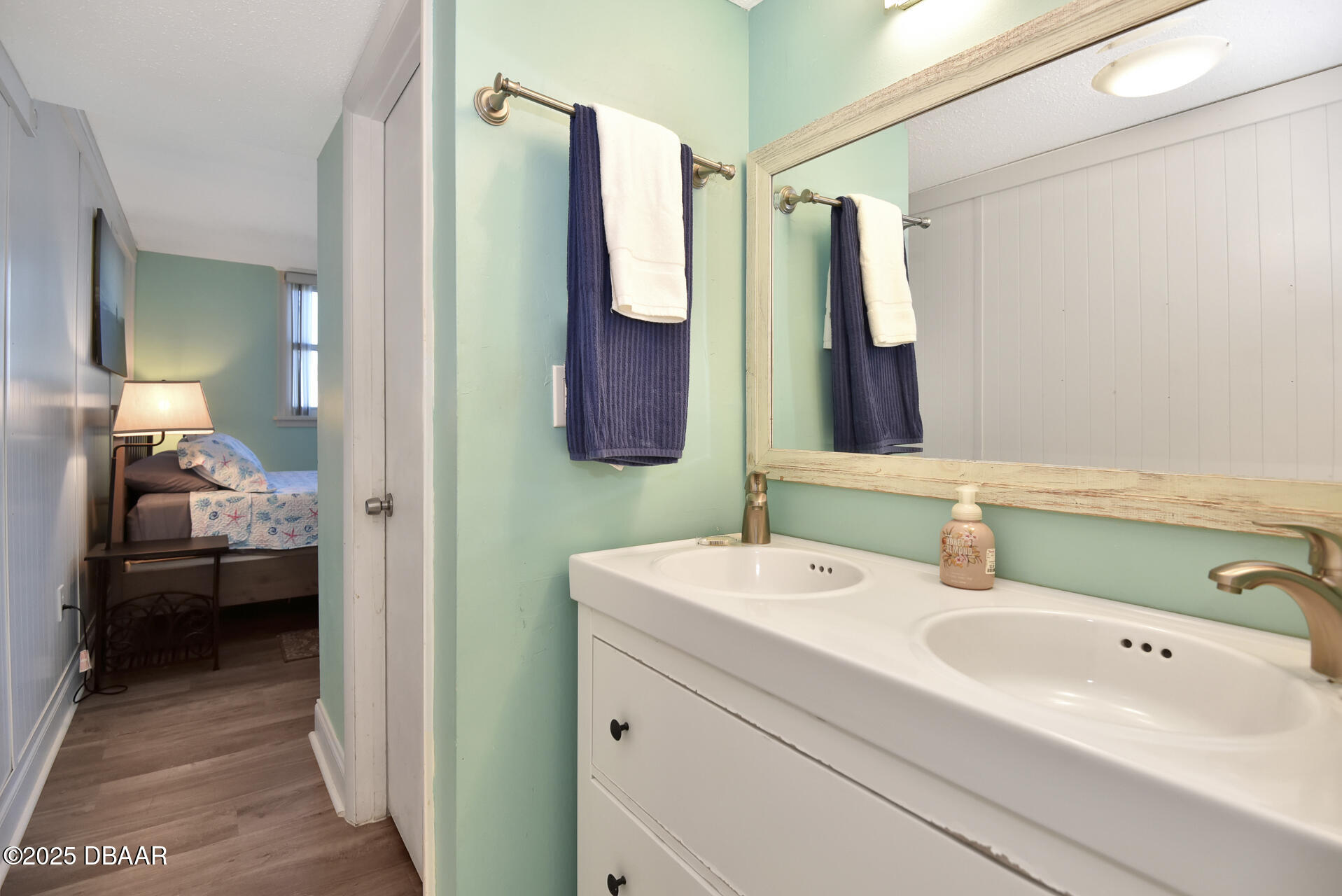 4495 South Atlantic Avenue, Unit 4040 Ponce Inlet, FL 32127 - Photo 33 of 45 a en suite bathroom with a sink and a mirror