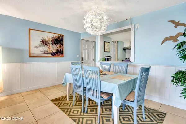 a view of a dining room with furniture and chandelier