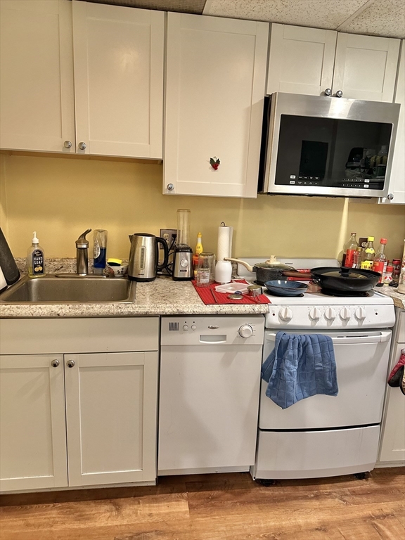 464 Commonwealth Avenue, Unit 38 Boston, MA 02215 - Photo 9 of 16 a kitchen with stainless steel appliances granite countertop a sink and a stove