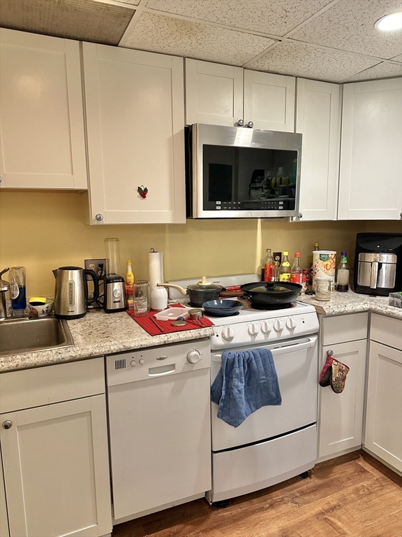 464 Commonwealth Avenue, Unit 38 Boston, MA 02215 - Photo 10 of 16 a kitchen with stainless steel appliances granite countertop a sink a stove and microwave