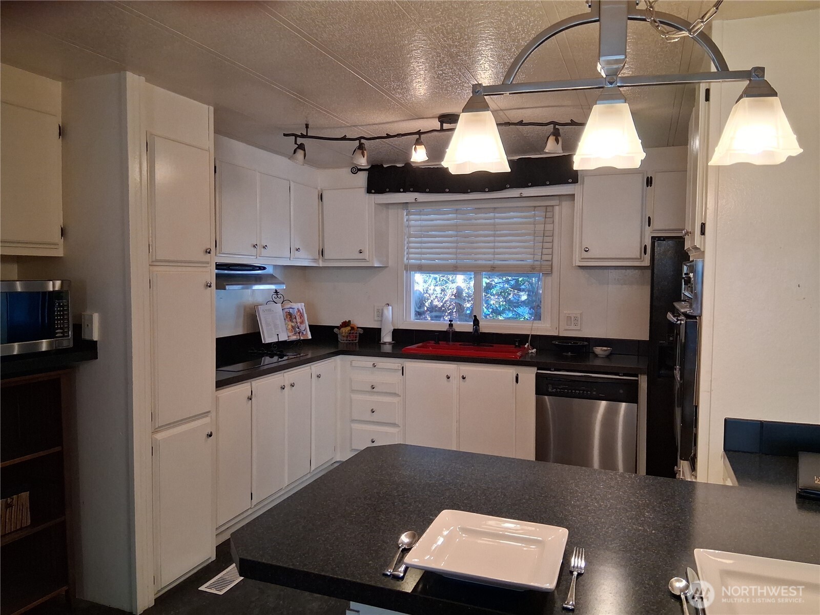 815 124th Street Southwest, Unit 36 Everett, WA 98204 - Photo 20 of 33 a kitchen with stainless steel appliances kitchen island granite countertop a sink a stove and cabinets
