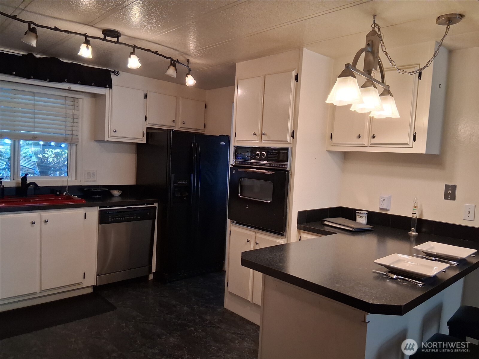 815 124th Street Southwest, Unit 36 Everett, WA 98204 - Photo 22 of 33 a kitchen with a refrigerator and a stove top oven