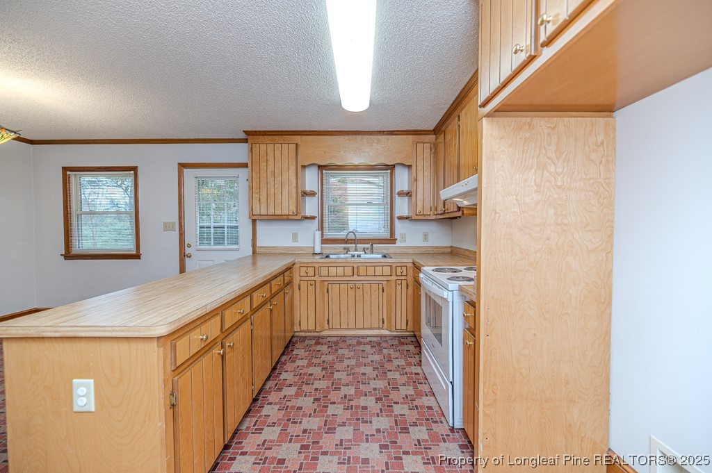 406 McFarland Road Broadway, NC 27505 - Photo 16 of 37 a kitchen with stainless steel appliances granite countertop a stove a sink and a refrigerator