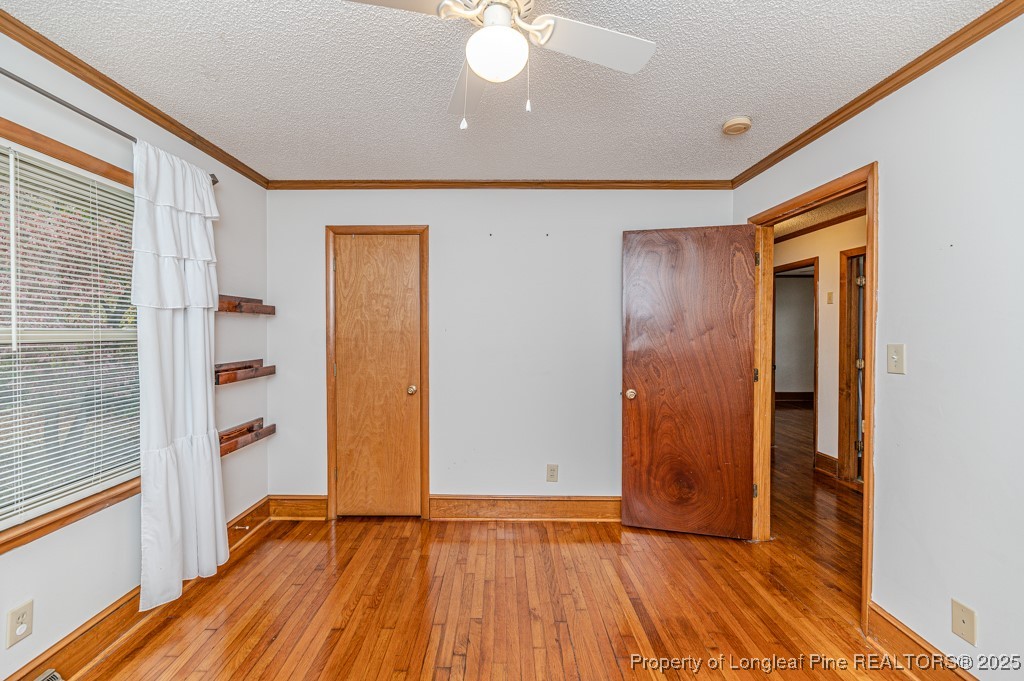 406 McFarland Road Broadway, NC 27505 - Photo 21 of 37 a view of an empty room with wooden floor and a window