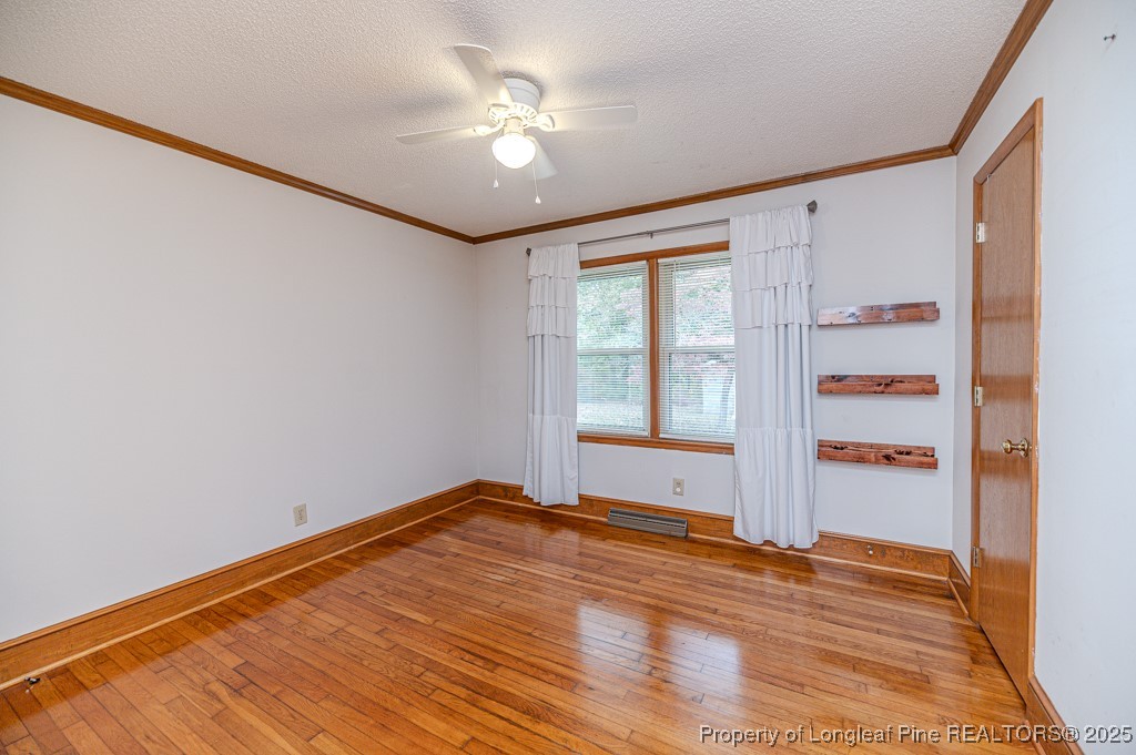406 McFarland Road Broadway, NC 27505 - Photo 23 of 37 a view of an empty room with a window and wooden floor