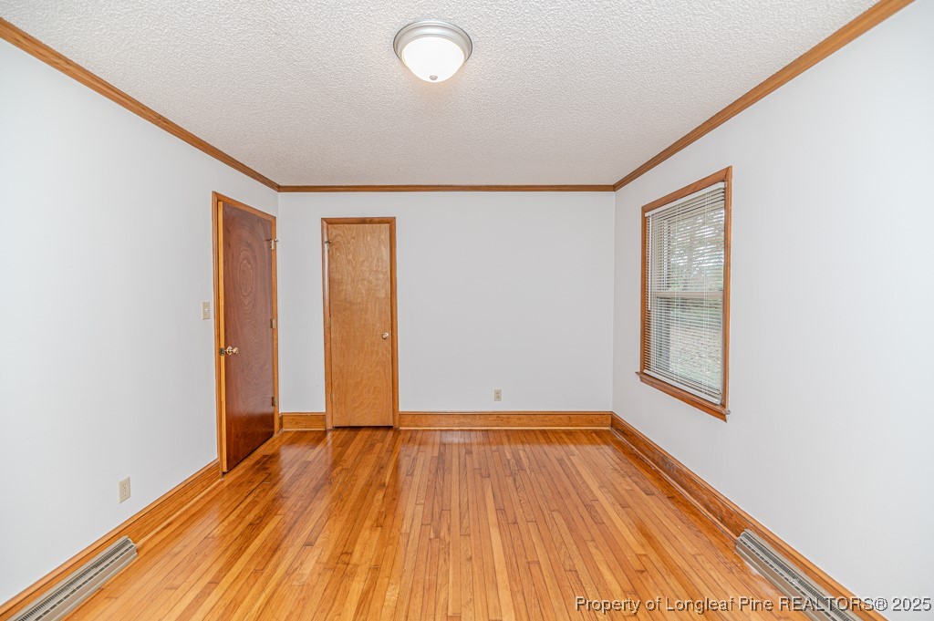 406 McFarland Road Broadway, NC 27505 - Photo 26 of 37 an empty room with wooden floor and windows