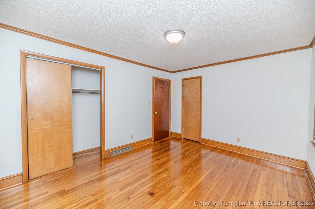 406 McFarland Road Broadway, NC 27505 - Photo 27 of 37 an empty room with wooden floor and closet