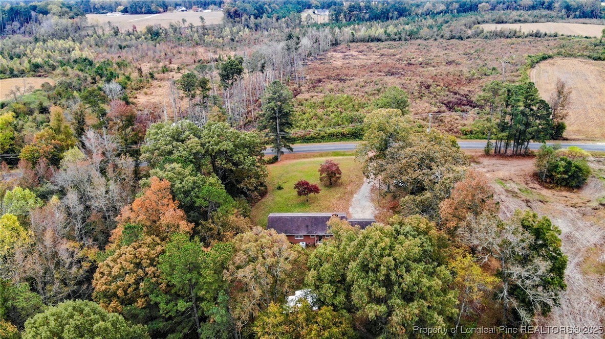 406 McFarland Road Broadway, NC 27505 - Photo 3 of 37 an aerial view of a house with a yard and large trees