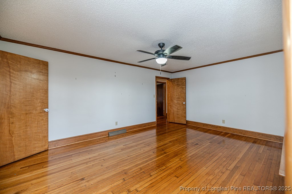 406 McFarland Road Broadway, NC 27505 - Photo 4 of 37 a view of an empty room with wooden floor